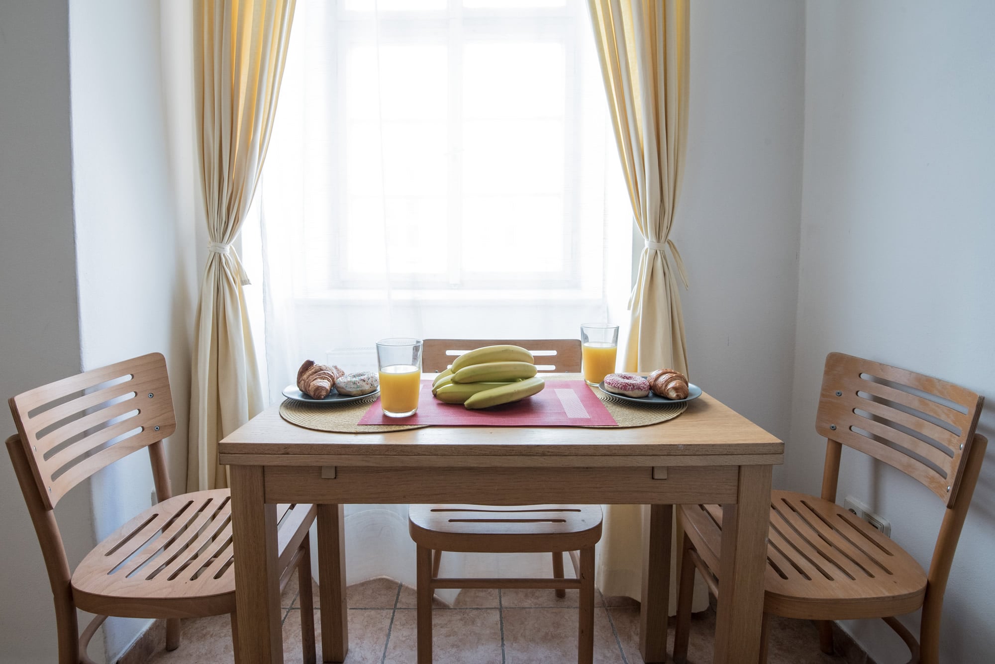 Dining table with breakfast in front of the window