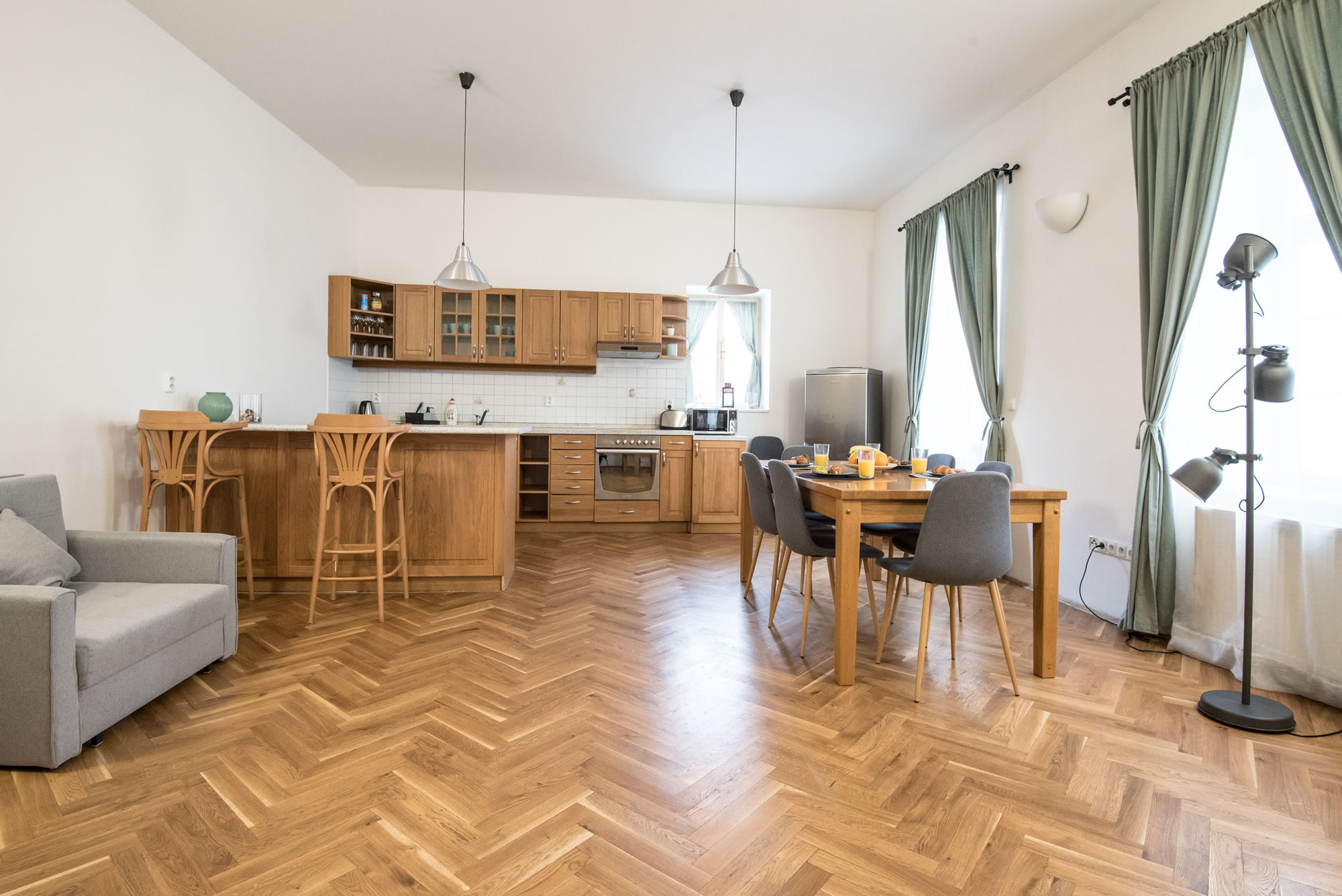 Duplex apartment with spacious kitchen, large dining table and a sofa chair