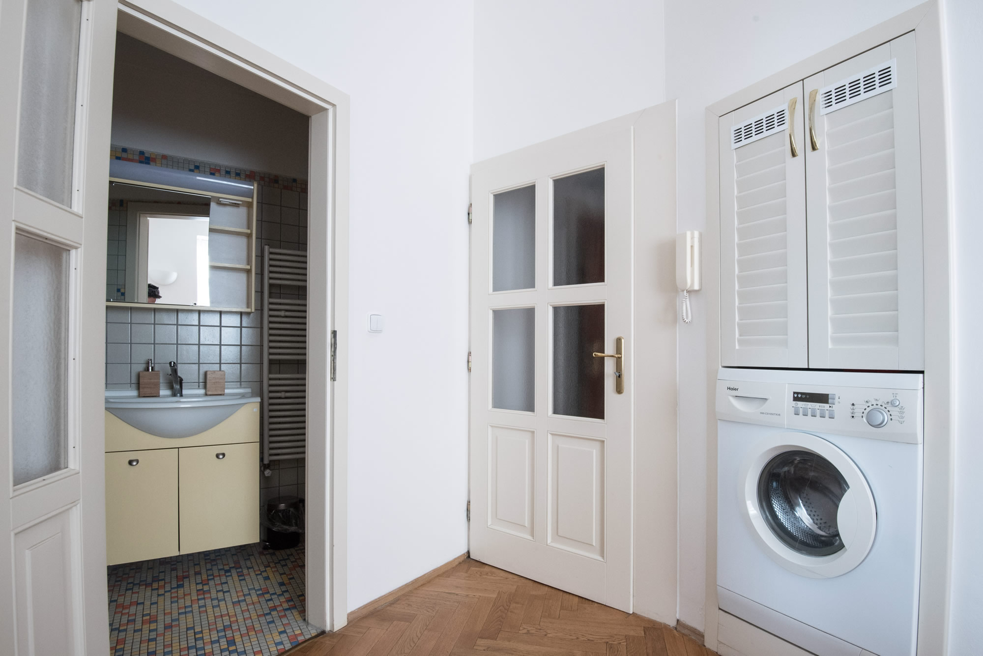 Apartment with a washing machine and bathroom.