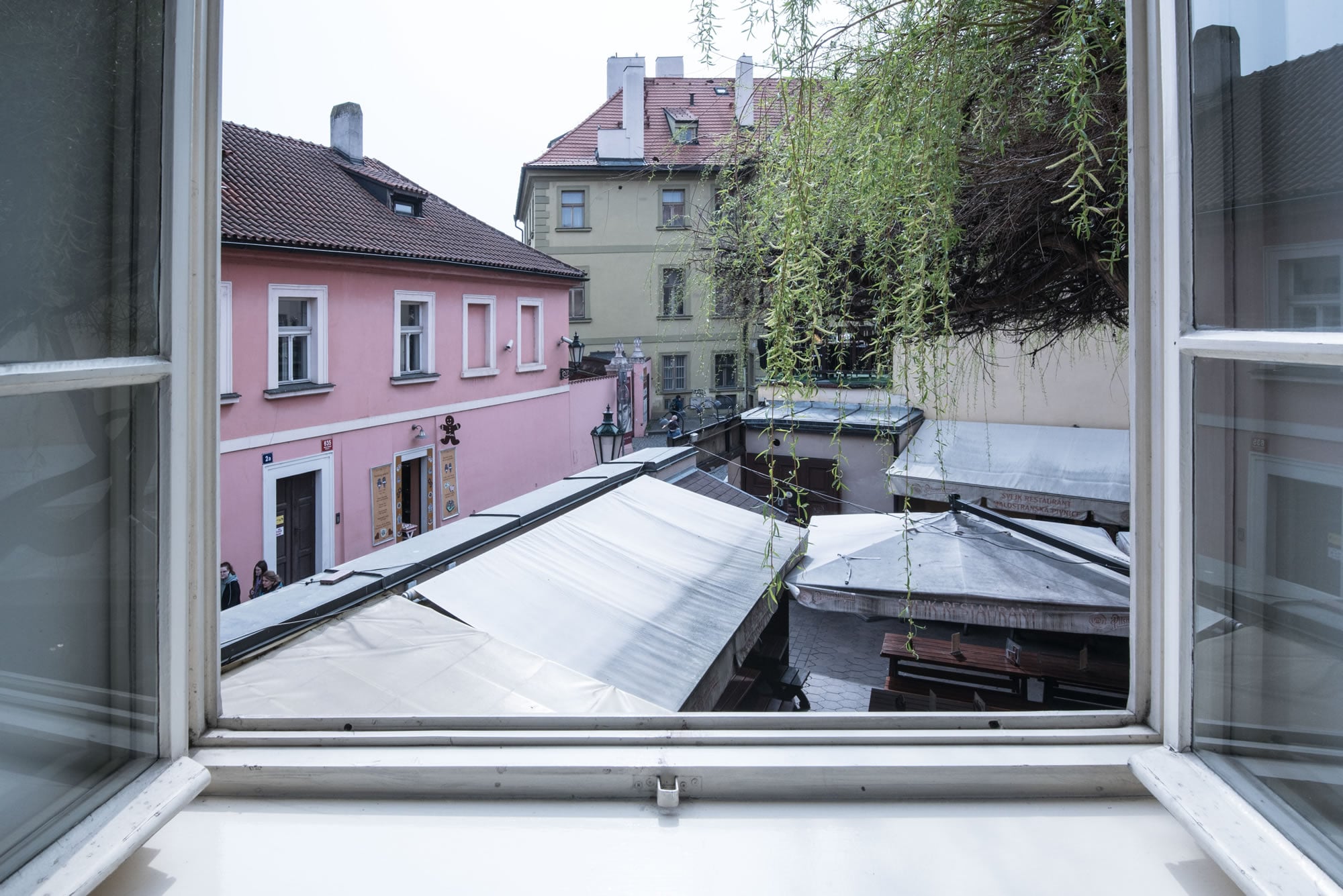 View from the window to the Svejk beer garden. Franz Kafka museum is behind.